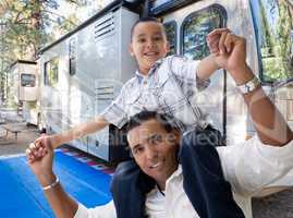 Happy Hispanic Father and Son In Front of Their Beautiful RV At