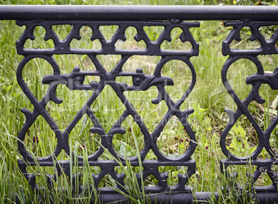Decorative metal fence at the sidewalk.