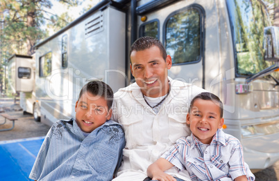 Happy Hispanic Father and Sons In Front of Their Beautiful RV At