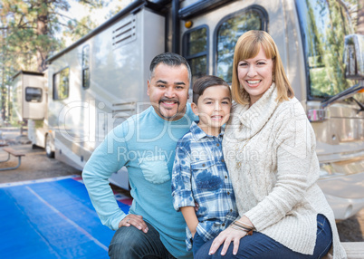 Happy Young Mixed Race Family In Front of Their Beautiful RV At