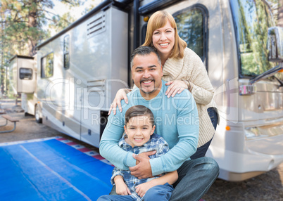 Happy Young Mixed Race Family In Front of Their Beautiful RV At