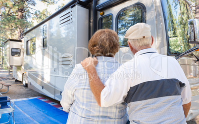 Senior Couple Looking At A Beautiful RV At The Campground.