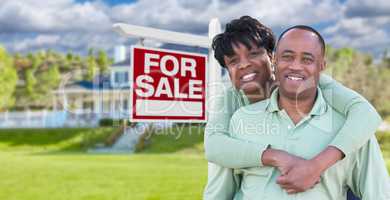 Happy African American Couple In Front of Beautiful House and Fo