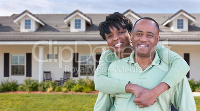 Happy African American Couple In Front of Beautiful House.