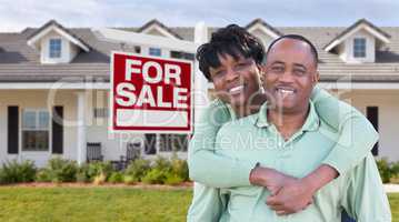 Happy African American Couple In Front of Beautiful House and Fo