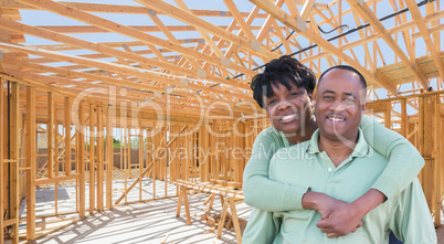 Happy African American Couple Inside Construction Framing of New