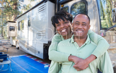 Happy African American Couple In Front of Their Beautiful RV At