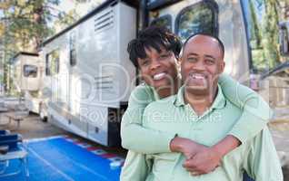 Happy African American Couple In Front of Their Beautiful RV At