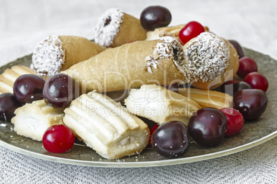 Biscuits and cherries on the plate. The view from the top