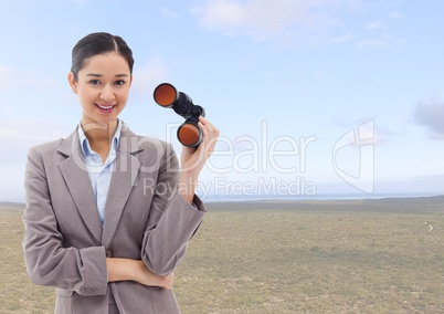 Businesswoman in nature with binoculars