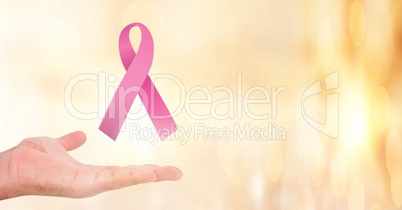 Open hand with pink ribbon for breast cancer awareness
