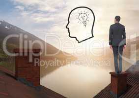Head and light bulb icon and Businessman standing on Roofs with chimney and lake mountain landscape