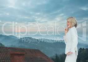 Businesswoman standing on Roof with chimney and misty landscape