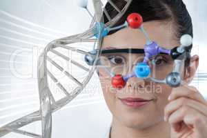 Doctor woman holding a medical figure  with 3D DNA strand