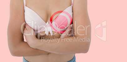 Composite image of woman in bra with breast cancer awareness ribbon