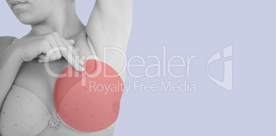 Composite image of mid section of woman in bra touching breast