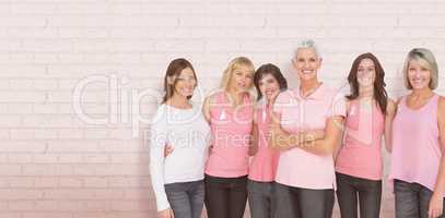 Composite image of portrait of confident women supporting breast cancer awareness