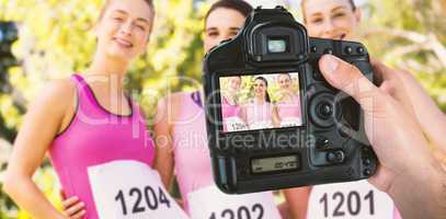 Composite image of cropped hand of photographer holding camera