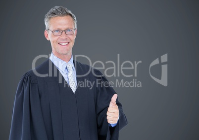 Male judge thumbs up against grey background