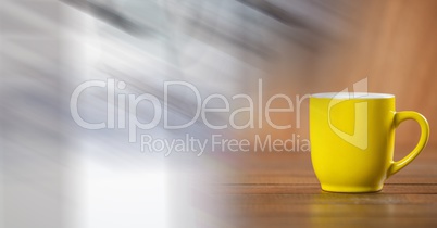 Yellow coffee cup with blurry white transition