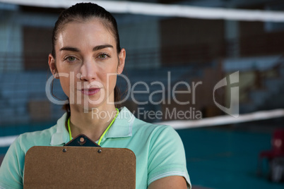 Portrait of volleyball coach with clipboard