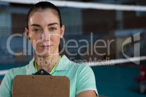 Portrait of volleyball coach with clipboard
