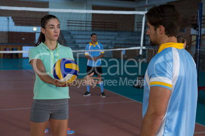 Male volleyball player practicing with coach