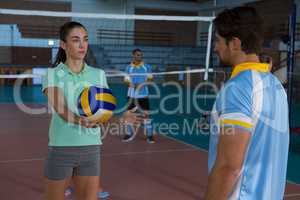 Male volleyball player practicing with coach