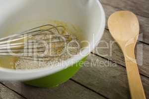 High angle view of egg and flour batter in bowl