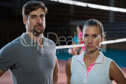 Portrait of confident volleyball players at court