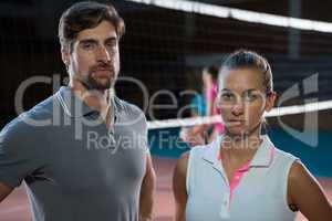 Portrait of confident volleyball players at court