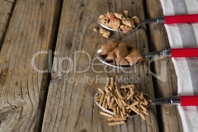 Three spoons with various breakfast cereals