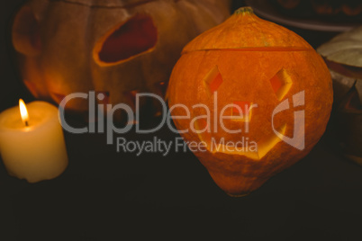 High angle view of illuminated jack o lanterns with candle