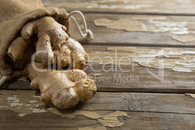 Close up of burlap and fresh gingers on weathered table