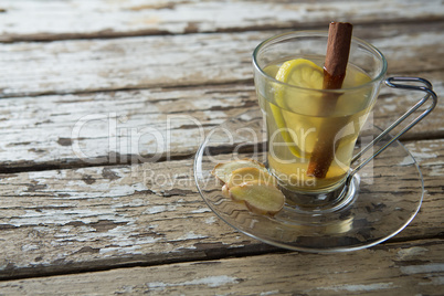 Close up of cinnamon and lemon in ginger tea on table