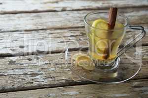 Close up of cinnamon and lemon in ginger tea on table