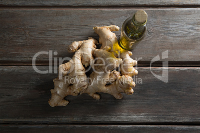 Overhead view of gingers by oil bottle on table