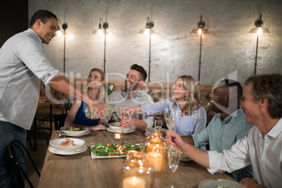 Man serving champagne to his friends