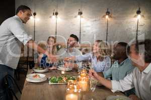 Man serving champagne to his friends