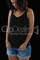 Woman stretching tank top over black background