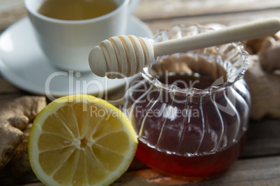 Close up of fresh honey and lemon with ginger tea