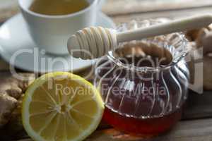 Close up of fresh honey and lemon with ginger tea