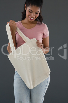 Smiling woman holding shoulder bag