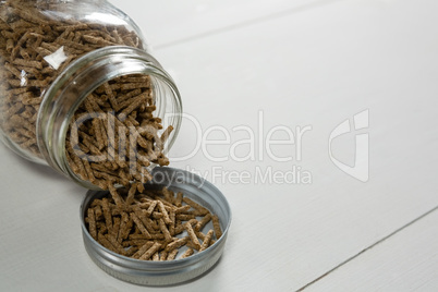 Cereal bran sticks spilling from glass jar