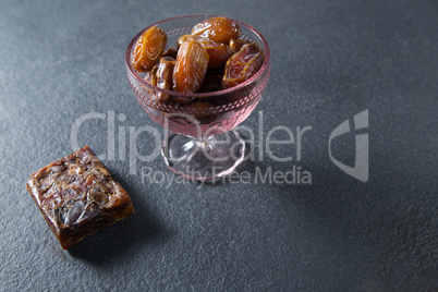 Dates fruits in glass bowl on slate