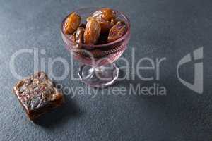 Dates fruits in glass bowl on slate