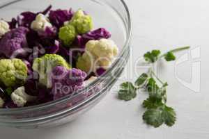 Close-up of cauliflowers with red cabbages in bowl