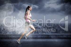 Composite image of profile view of sportswoman running on a white background