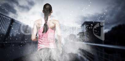 Composite image of rear view of woman running against white background