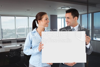 Business people holding blank card in office